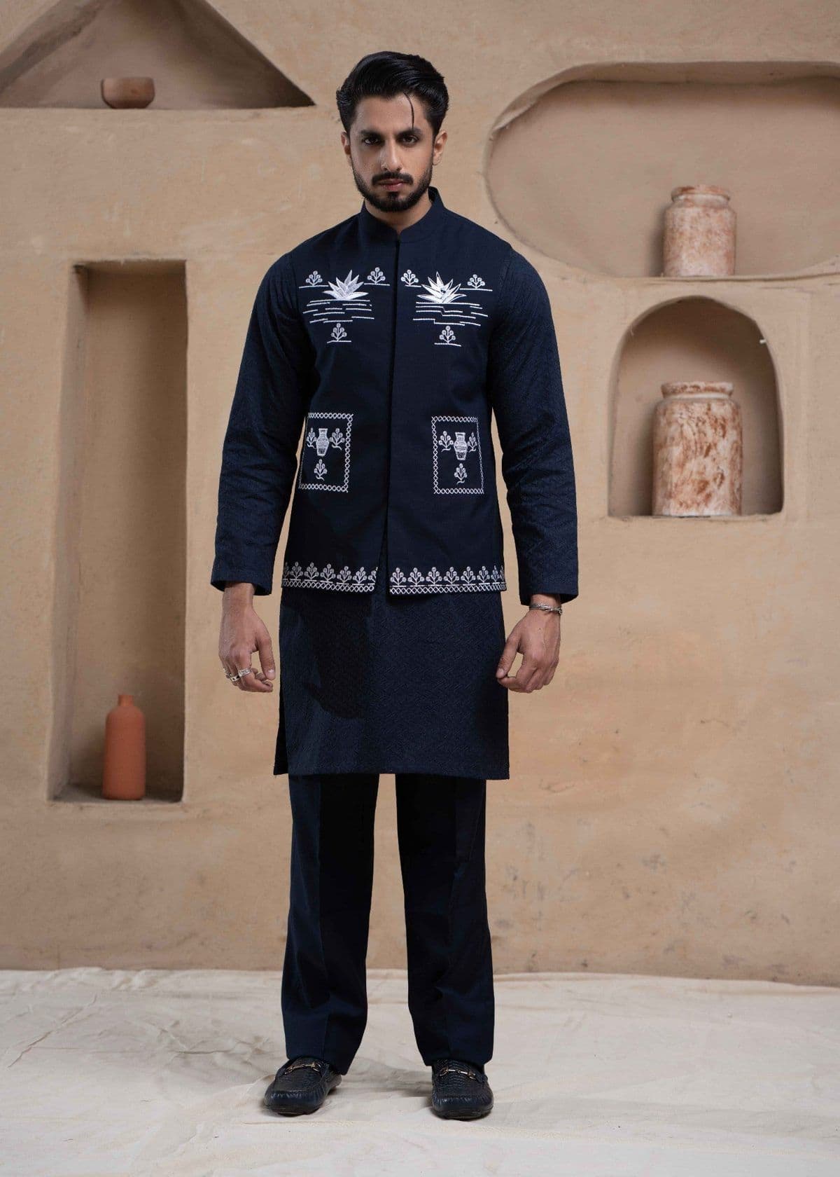 Navy embroidered waistcoat over a navy kurta and trousers